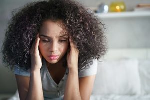 woman meditates during therapy at opioid addiction treatment center