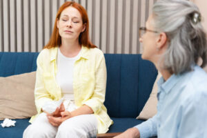 A woman is struggling with OCD postpartum and is receiving treatment from a therapist.