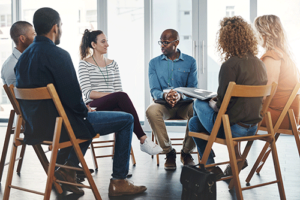 People sit in group therapy during prescription drug addiction treatment